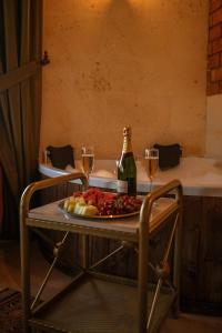 a table with a plate of food and two glasses of wine at Zeppelin Cappadocia in Uçhisar