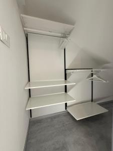 an empty refrigerator with white shelves in a room at City Garden in Rovigo