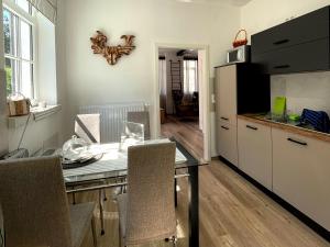 a kitchen with a table with chairs and a counter top at Thüringer Wald-Zauber in Zella-Mehlis
