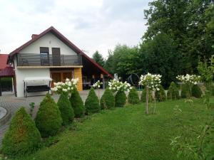 a row of trees in front of a house at Domek Gniewoszówka in Rymanów