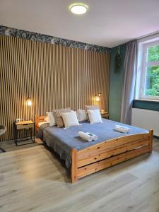 a bedroom with a large bed with two towels on it at Hotel Zur Luppbode in Treseburg
