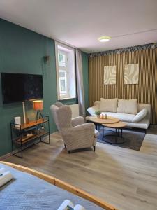 a living room with a couch and a table at Hotel Zur Luppbode in Treseburg