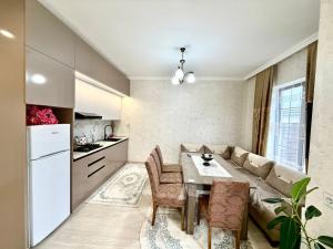 a kitchen and living room with a table and a couch at Samall new villa FRHD in Gabala