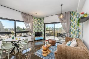 a living room with a couch and a table at Penthouse with pool jerusalem in Jerusalem