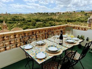 a table on a balcony with a bottle of wine at Karaktervolle modern uitgeruste woning - Casa Di Martile in Loreto Aprutino