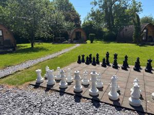 a chess set on a sidewalk with a yard at Cozy bell tent with heating and smart Tv in Llanfairpwllgwyngyll