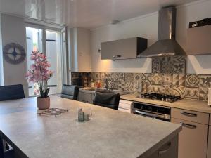a kitchen with a counter top and a stove top oven at Maison de ville in Cognac