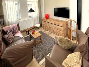 a living room with two couches and a television at Thüringer Wald-Zauber in Zella-Mehlis