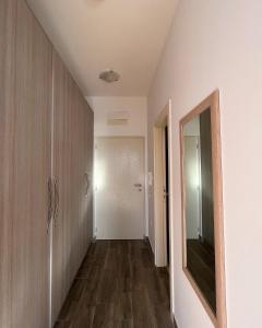 an empty hallway with a mirror and a door at Paradise Apartments Becici in Becici