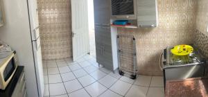 a small kitchen with a yellow toy on the counter at Casa com Ar condicionado a 50m da praia de Riviera in Bertioga +7 photos