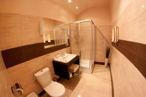 a bathroom with a sink and a shower and a toilet at BedRooms 3 Maja 15A in Łódź +25 photos
