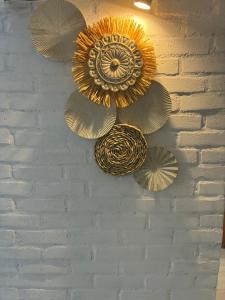 a wall with several metalwheels hanging on a wall at Marcia's Welcome House in Rafina