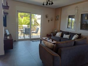 a living room with two couches and a table at Mitikas Resort in Mytikas
