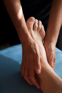 a person holding the foot of another person at Alabianca in Villa Vela