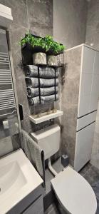 a bathroom with a white toilet and a sink at Lux Apartman Stojanović in Belgrade +32 photos