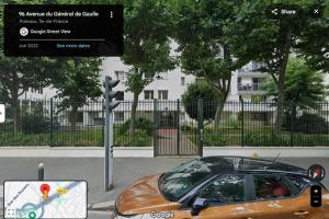 a car parked in a parking lot next to a street at Spacious T3 appart nearby la defense & Arena in Puteaux +2 photos