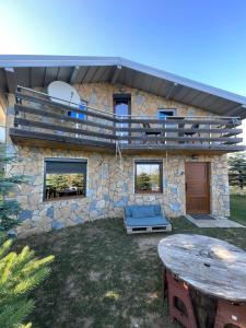 a stone house with a table in front of it at Villa 80 Kodra e Diellit in Tetovo