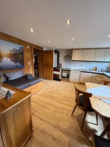 a large kitchen with a table and a dining room at Talgenbichl in Bruck am Ziller