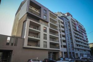 a tall building with cars parked in front of it at Angela Suite - Luxury loft near Politecnico and city center in Turin