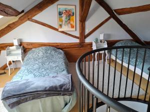 a bedroom with a bunk bed and a staircase at Le Sept-Maison du XVII ème siècle 