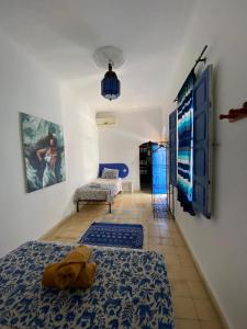 a room with a bed and a chair and a tv at Riad Safi médina in Safi +40 photos
