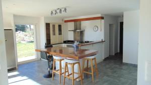 a kitchen with a wooden counter and a kitchen island at La Pampa au Mas des Issarts in Saint-Jean-de-Fos