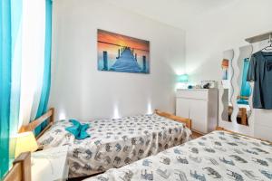 a bedroom with two twin beds and a window at Holiday Home & Apartments Primavera in Pula