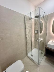 a bathroom with a shower and a toilet and a sink at Elysium Relais in Naples +41 photos