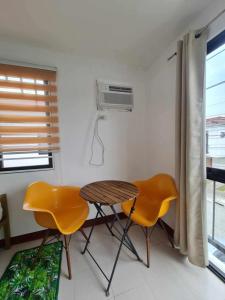a room with a table and two chairs and a heater at Casa Lyma in Candelaria