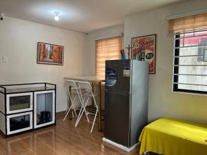a kitchen with a refrigerator and a table in it at Casa Lyma in Candelaria