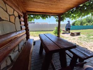 a wooden picnic table sitting under a pavilion at RETRO Apartmány Podhájska in Podhájska