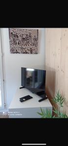 a computer monitor sitting on a white desk at Studio à Port Grimaud in Grimaud