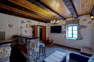 a living room with a stone pillar and a window at Kuća za odmor Tonka in Grižane