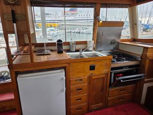 a kitchen with a sink and a stove and a window at bateau de légende in Toulon +29 photos