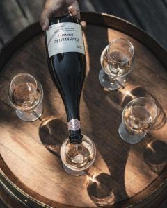 a person is pouring a glass of wine on a table at Quinta da Torre - Anselmo Mendes  +11 photos