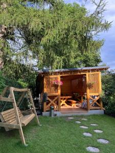 a gazebo with a bench and a swing at Home by Ginger in Reichenbach im Vogtland +81 photos