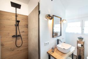 a bathroom with a shower and a sink at Ferienbahnhof Fichtental Bahnhofs-Loft in Prackenbach +11 photos