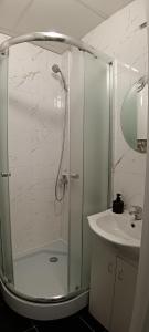 a bathroom with a shower and a sink at Sea&Sun in Liepāja +8 photos