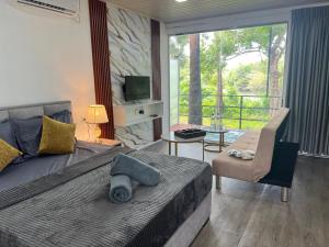 a bedroom with a large bed and a balcony at Leopard Inn Wilpattu in Ilavankulam