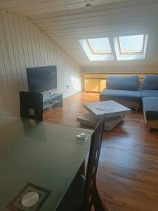 a living room with a couch and a table and a tv at Ellen in Bad Ems