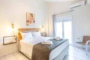 a bedroom with a bed with towels on it at Sofia's seaview house in Platanias