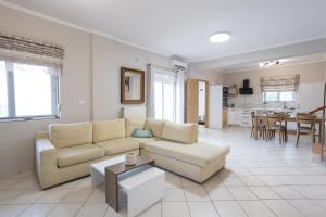 a living room with a couch and a table at Sofia's seaview house in Platanias