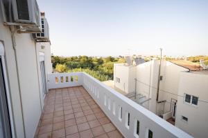 a balcony with a view of the city at Sofia's seaview house in Platanias