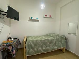 a room with a bed and a flat screen tv at Departamento Adrián in Mar del Plata