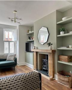 a living room with a fireplace and a mirror at Emerson House 2Bed Sleeps 6 EV Point Dog Friendly Parking Groups Families Professionals in Poole