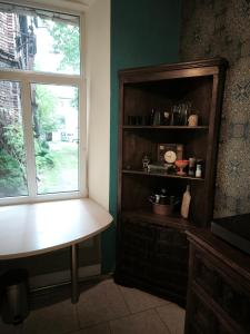 a kitchen with a table and a window and a shelf at Sekret Maharadży - The Maharaja's Secret in Częstochowa +18 photos
