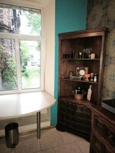 a kitchen with a table and a window in a room at Sekret Maharadży - The Maharaja's Secret in Częstochowa