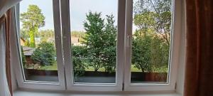an open window with a view of a garden at Sea&Sun in Liepāja