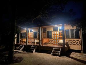 a house at night with chairs and a table at Retazos Eco Hotel in Iquitos