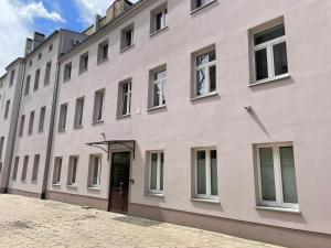 a large white building with a brown door at Cherry Apart Legionów 24 in Łódź